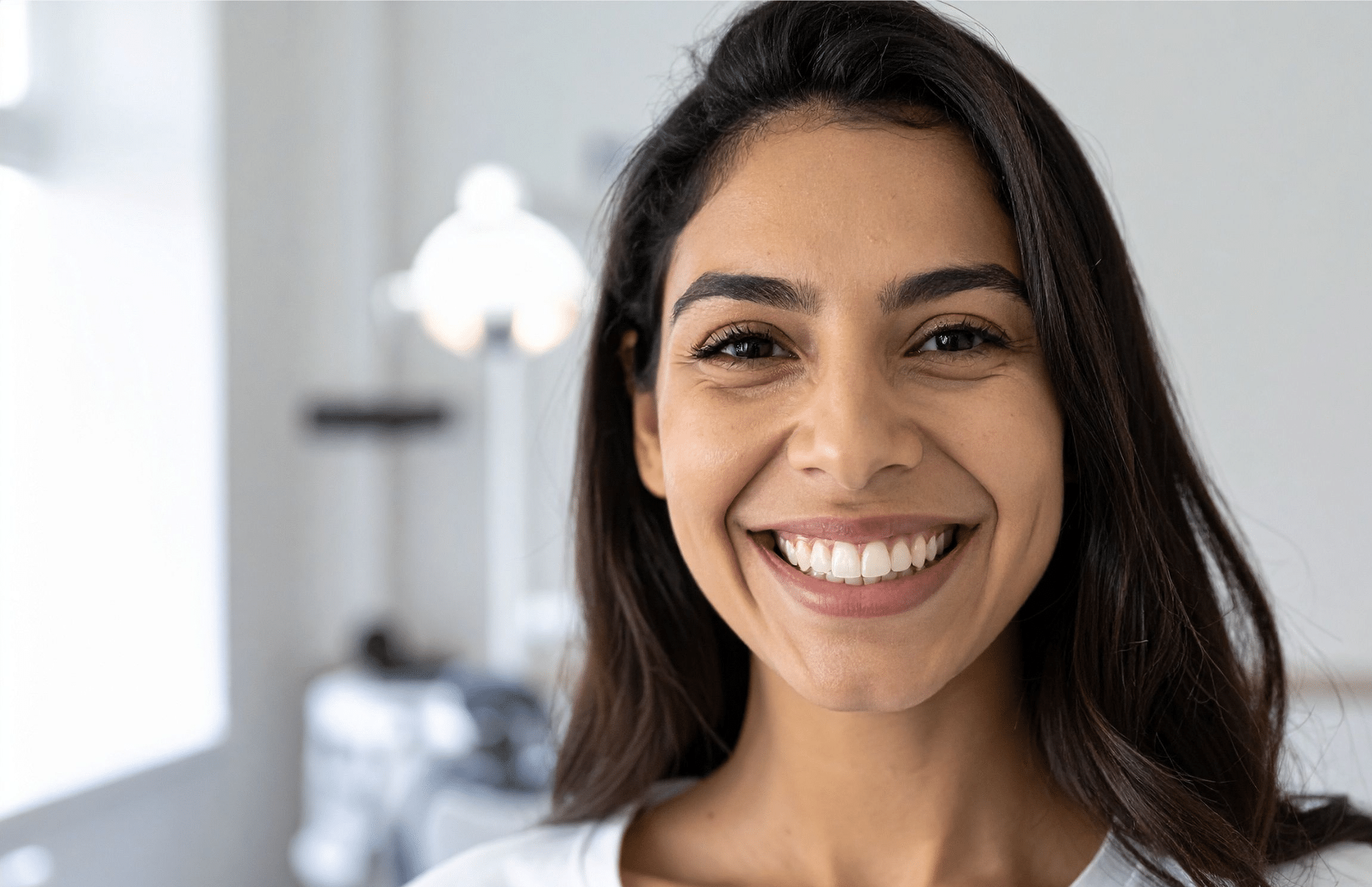 portrait of a woman with a perfect smile after having porcelain veneers done at Pacific Northwest Smiles at Mill Creek