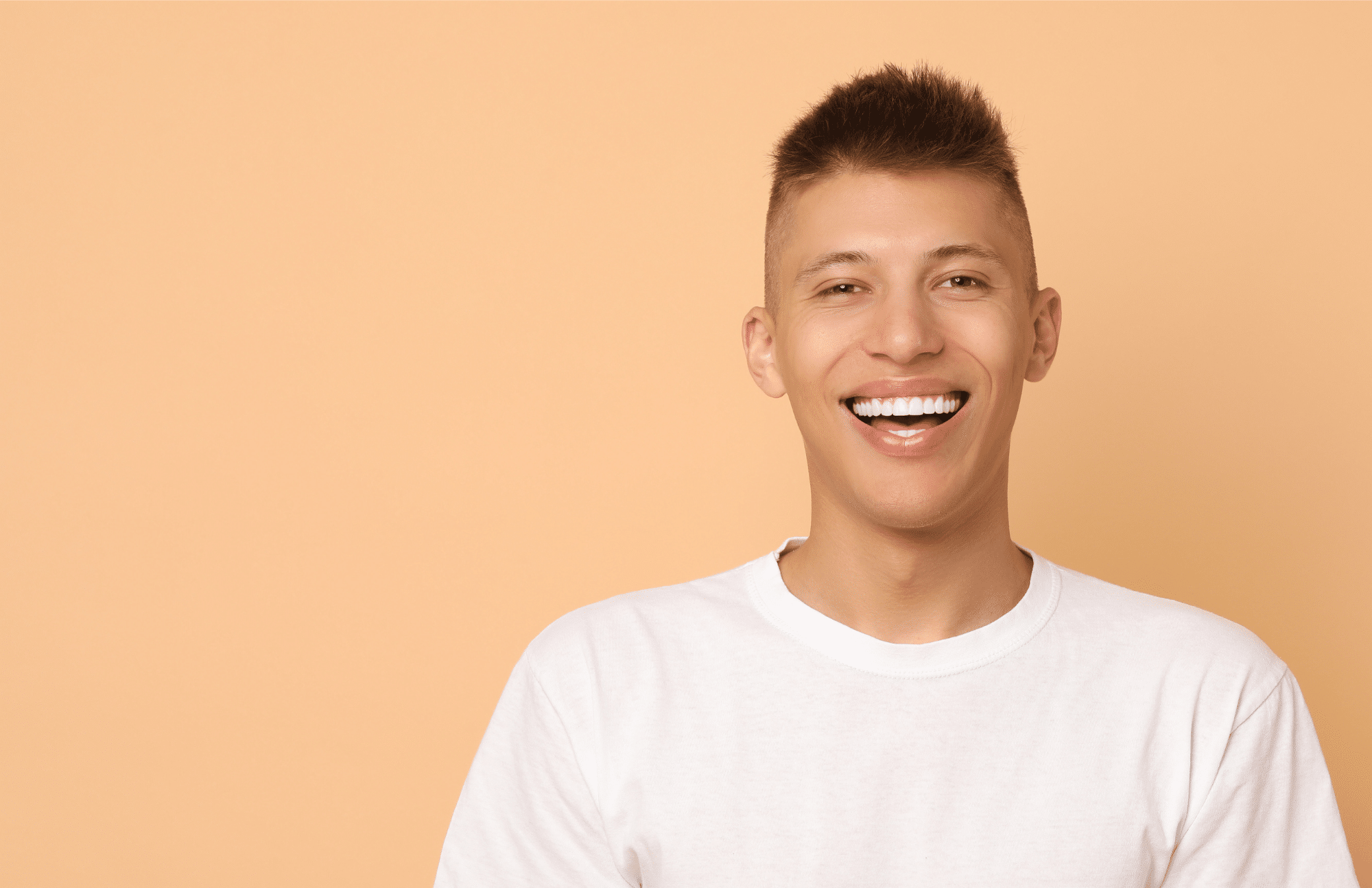 young man smiling confidently after having a veneers at Pacific Northwest Smiles at Mill Creek